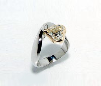 ハートカットのダイヤが印象的なリング。ダイヤ周りはゴールドで。